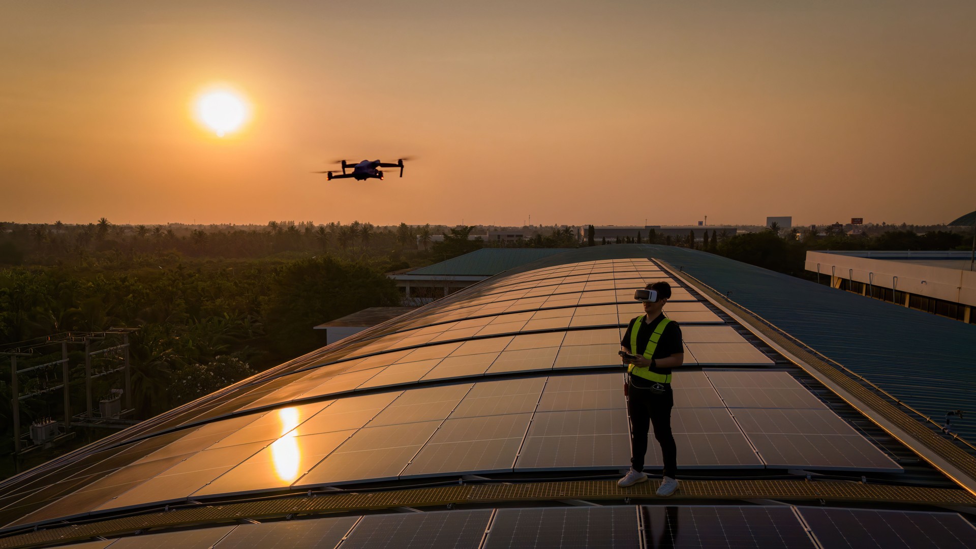 Engineers  use drones to explore solar panels or solar cells on the roof top factory. power plant with green fields renewable energy Eco-technology. Inspector engineer inspect and checking solar panel from  Drone on solar roof factory