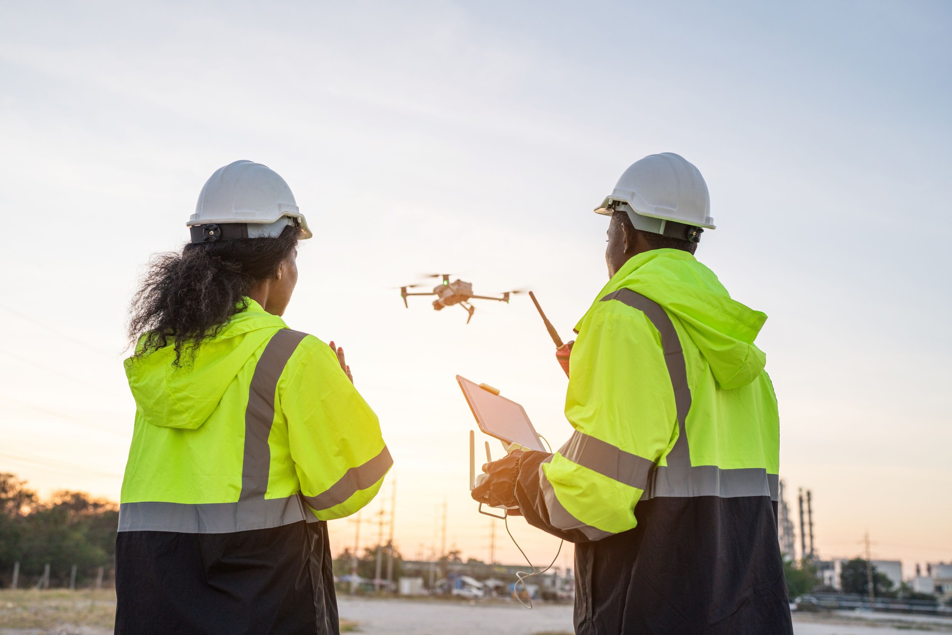 Team of Engineer Specialists Pilot Drone on Construction Site.