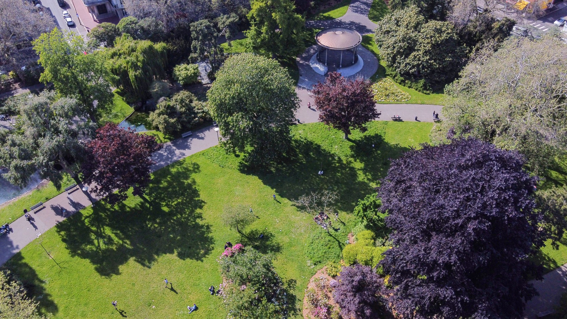 Amazing drone view on citypark in Le Havre  with people om green grass (distant)